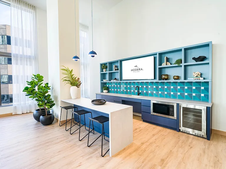 Bright and inviting resident kitchen at Modera Riverside, designed for gatherings with a touch of Miami flair.