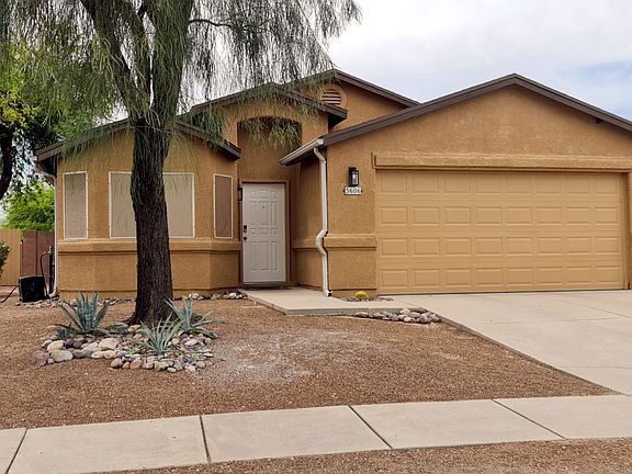 Front of home, showing updated landscaping and side yard entrance.