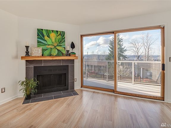 Living room opens to balcony with Auburn Valley view