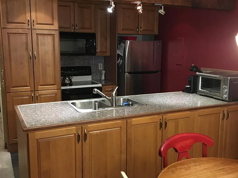 Kitchen area with brand new fridge.