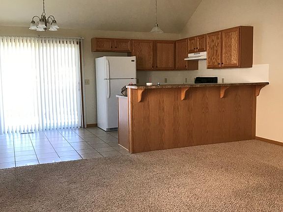 Vaulted ceilings over the kitchen and living area. Refrigera