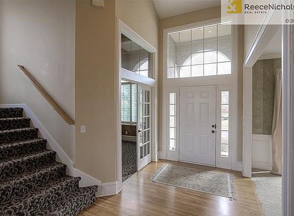 Bright entry with designer fixture, newer stairway carpet and refinished hardwood floors.