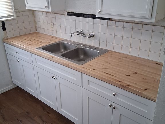 Lower kitchen cabinets and butcher block top just installed. Floor is 2 years old.
