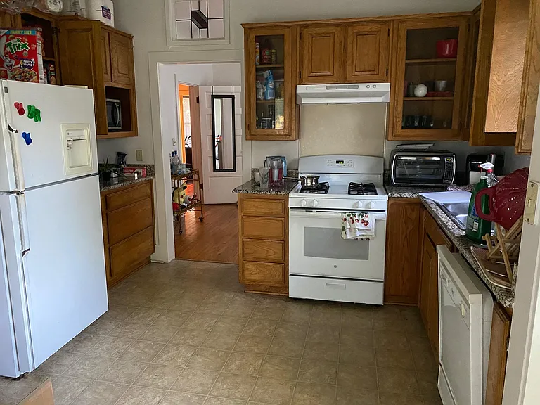 Kitchen - 9 ft ceiling, lots of wooden cabinets, granite countertops, gas stove, vent hood, dishwasher, garbage disposal, refrigerator with ice maker, pantry, vinyl flooring. Has a window with blind over the kitchen sink.