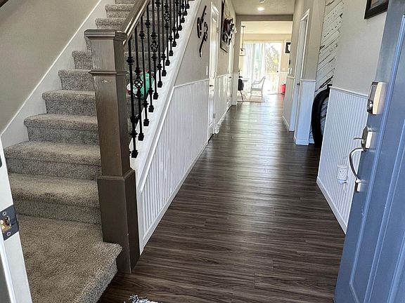 Entry way with stairs on the left leading to additional bedrooms, master suite, bonus room and laundry room.