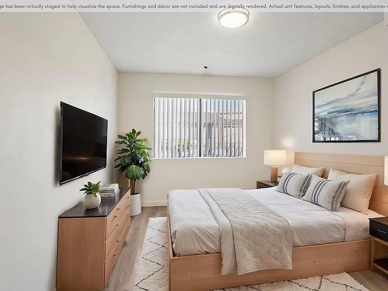 Spacious bedroom with updated flooring, natural light, and a clean modern design.