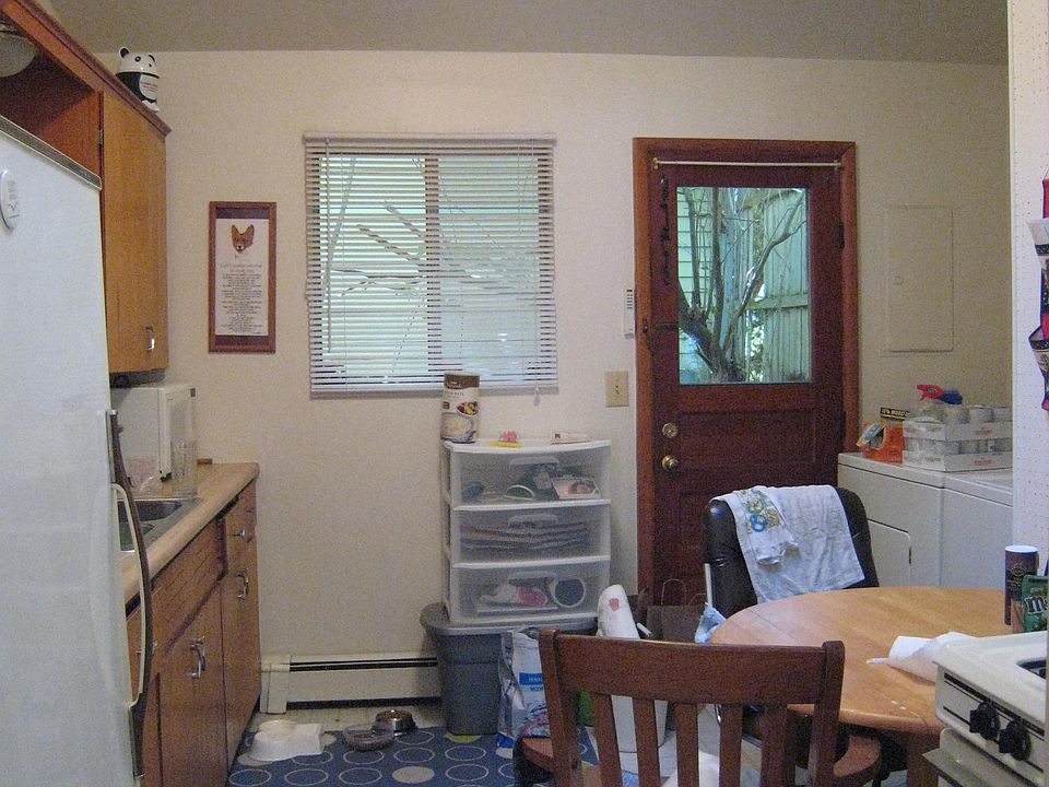 Kitchen, view to west side door.
(Furniture not included. Furniture and belongings shown was owned by prior tenant.)
