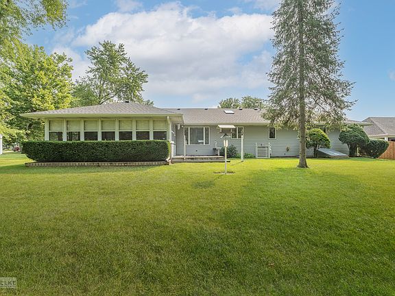 Look out over the large yard and lake from your sunroom!