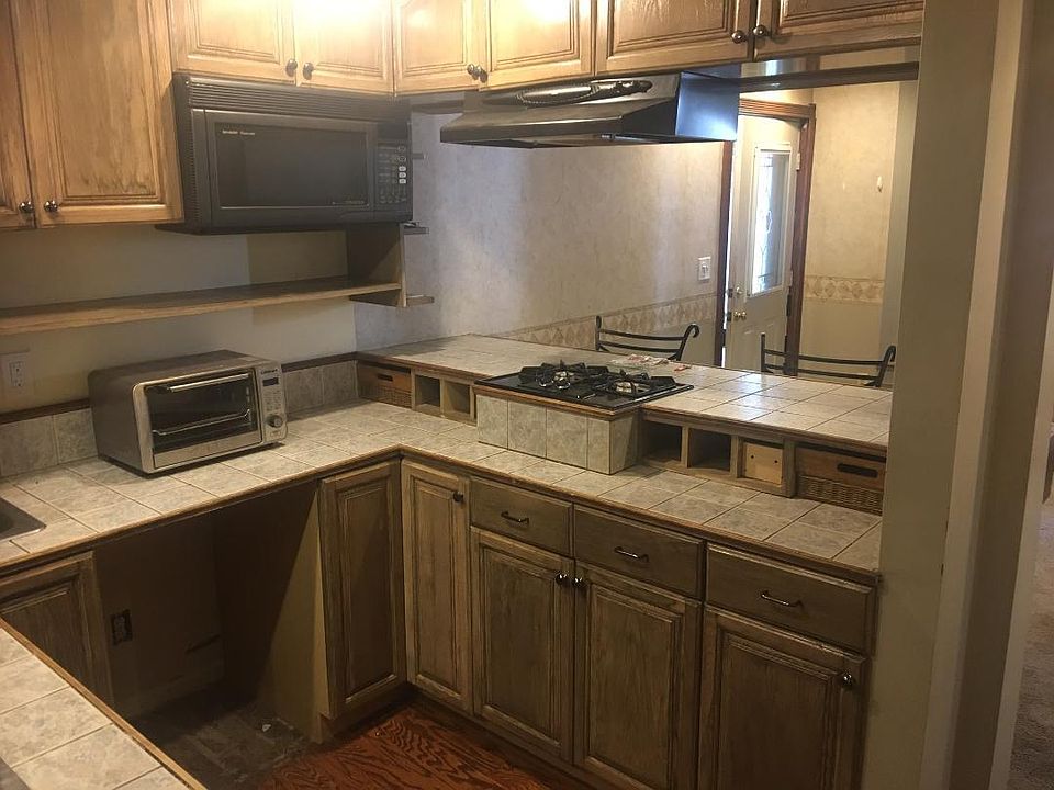 Kitchen opens into Living room and seating area. Small but functional.