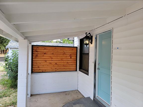 Such a cute custom wood sun shade at front porch.