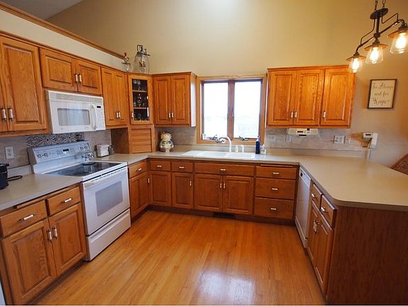 Exceptionally large kitchen complete with a pantry walls, vaulted ceilings & oak floors.
