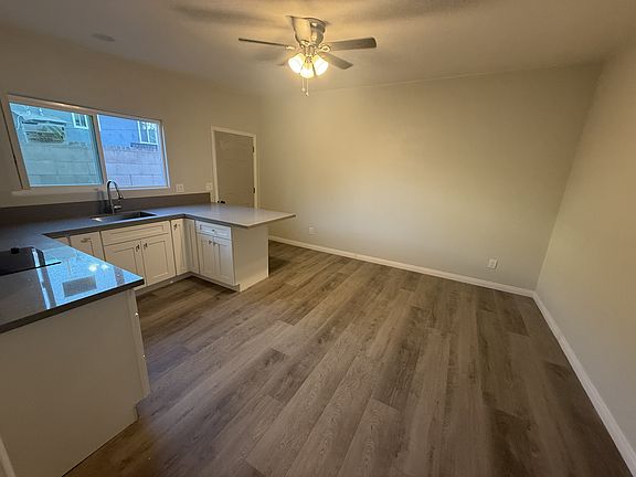 view from bedroom door to kitchen and living area