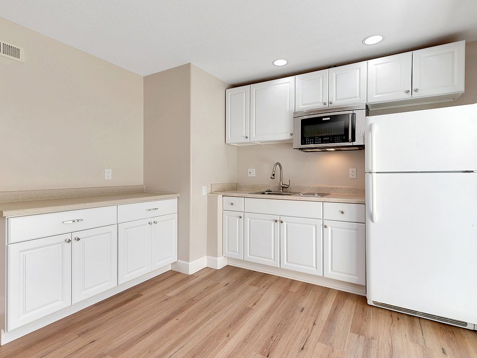 Kitchen includes 2-burner cooktop, microwave/convection oven, refrigerator, and garbage disposal