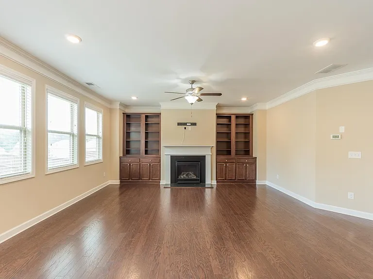 Great room/family room with wall units and bookcase, gas fireplace
