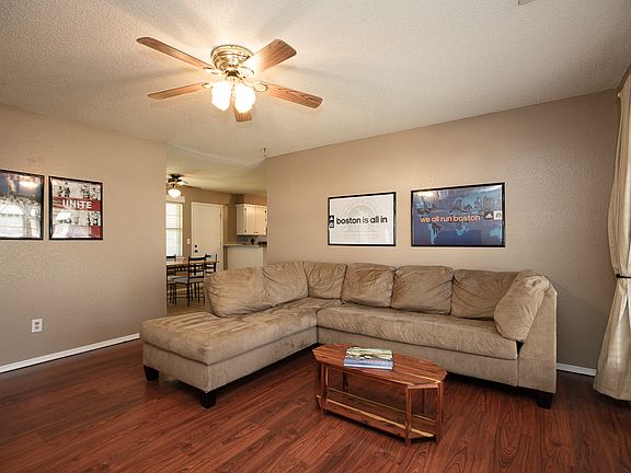 Expansive walk-through opens to Kitchen and Dining.