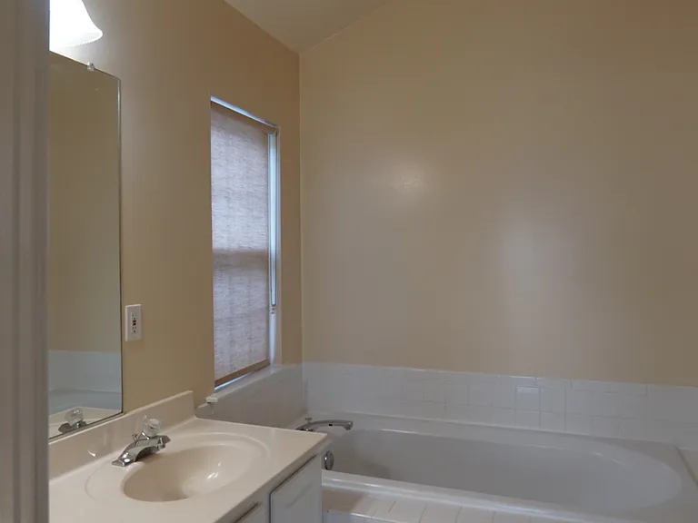 Primary en suite full bath, shower, two sinks, and separate soaking tub