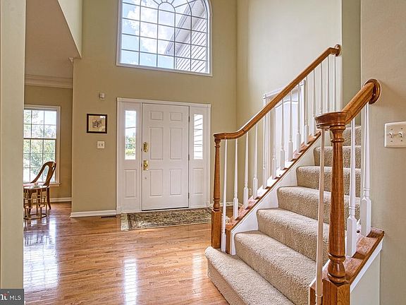 Expansive foyer with hardwood floors and cathedral