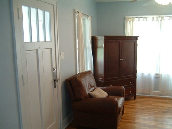 Bright living room with new windows and hard wood