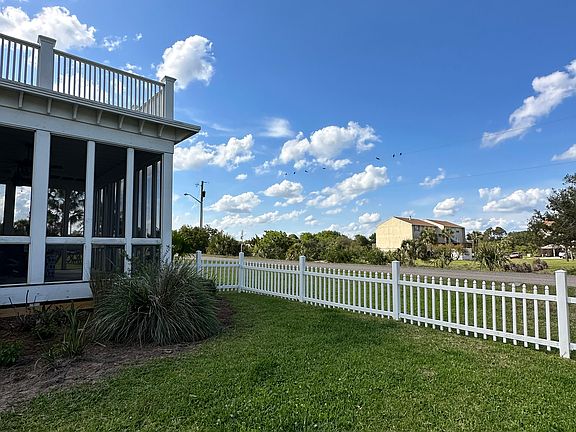 Backyard view of porch and open area facing toward Ft. Clinch
