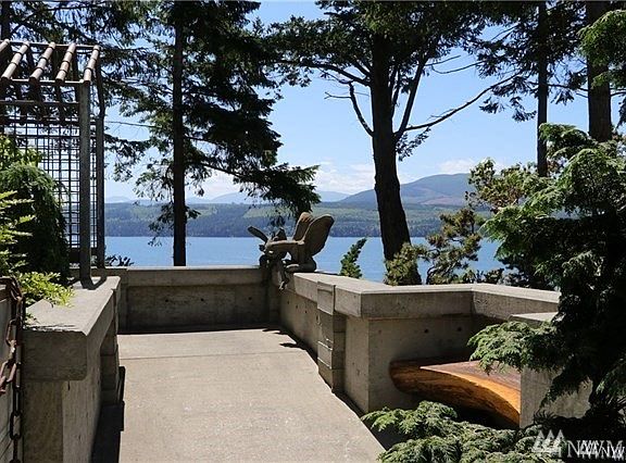 Through the arbor into the walkway to the home. Every turn is a visual delight filled with whimsical artistic touches.