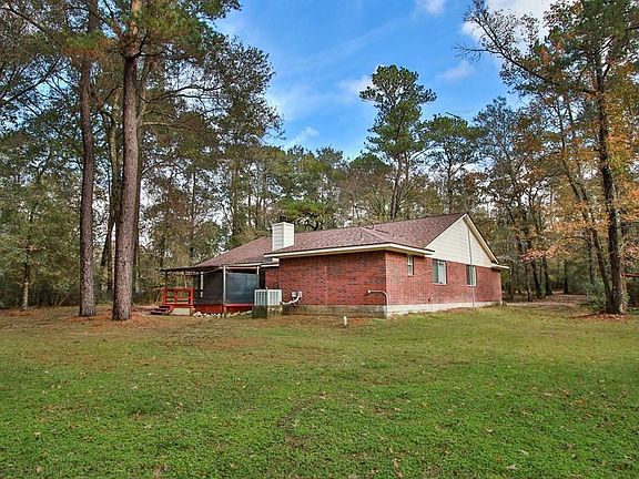 Back area around the house. The home shows that all four exterior walls are brick.