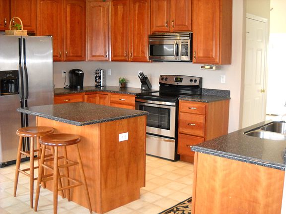 cherry cabinets with stainless steel cabinets