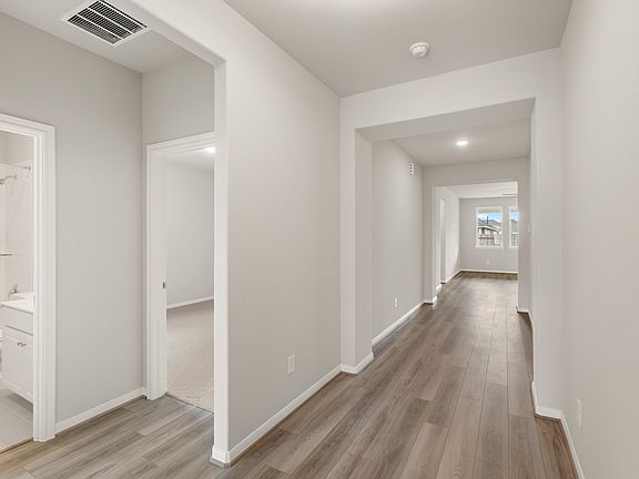 The entryway features gorgeous flooring and leads to the open concept living space.