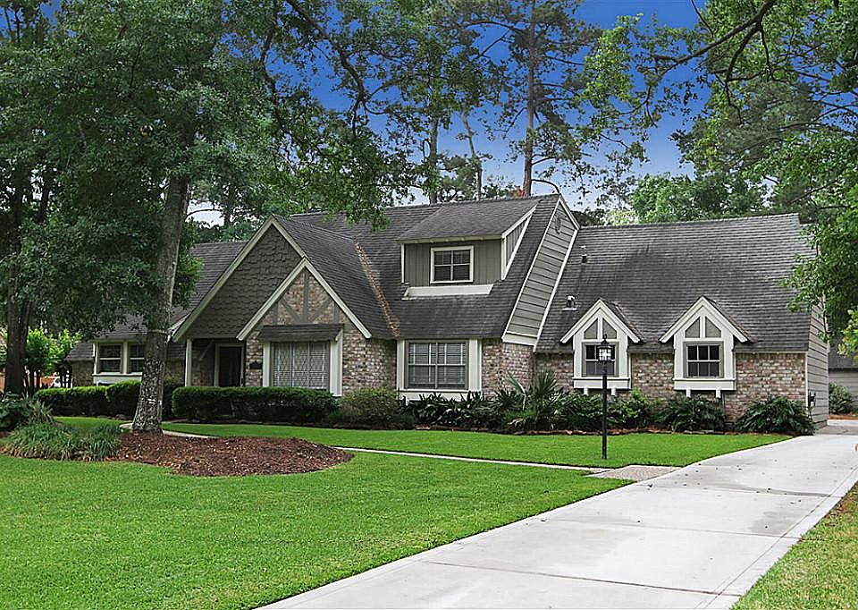 Exquisite traditional home nestled amongst mature trees and lush landscaping.