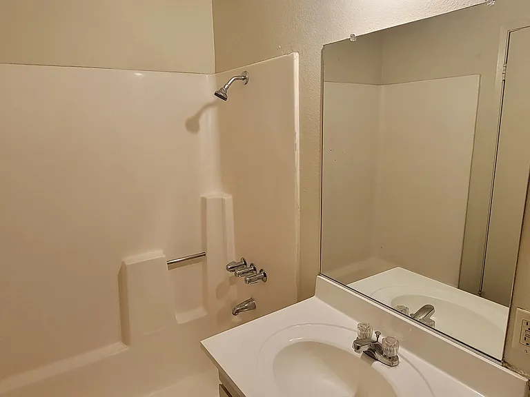 Tub and shower in ensuite unit at Magnolia Apartments in Riverside, California.
