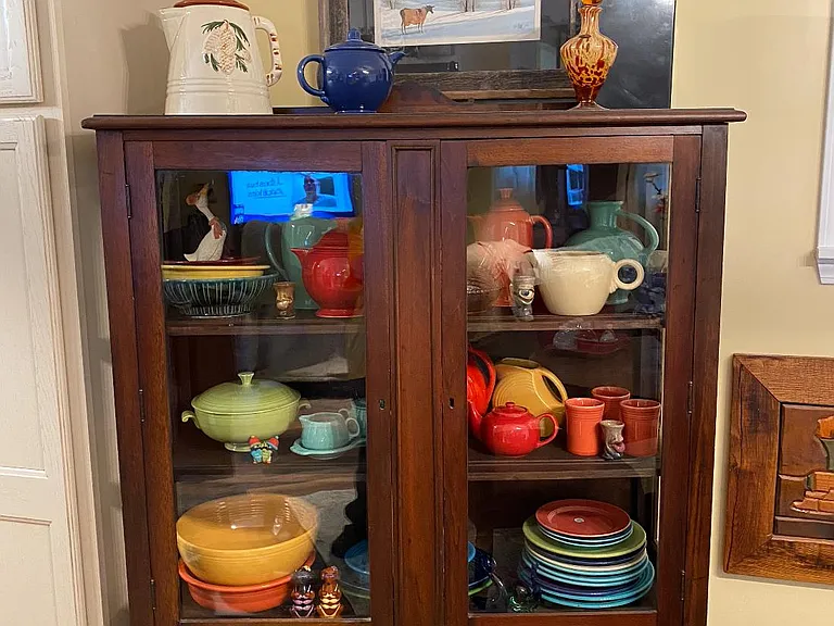 Antique china cabinet with fiestaware.