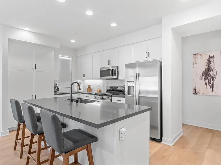Bar height seating is available for three from the kitchen Island.