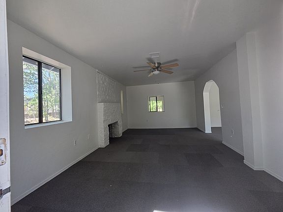 large living room with decorative (nonworking) fireplace.