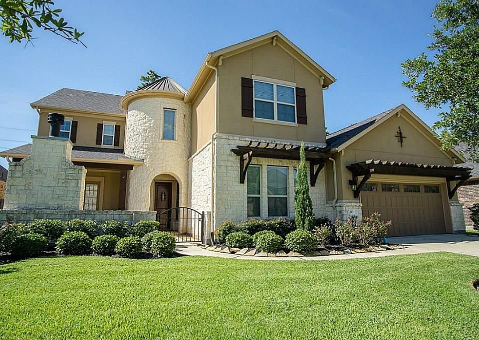 Welcome home to 14215 Spindle Arbor Road in the gated community of Park at Arbordale! This breathtaking home offers great curb appeal with its stone & stucco exterior surrounded by lush landscape!