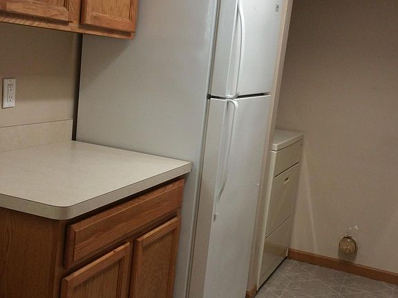 Galley kitchen...with refrigerator and washer & dryer.