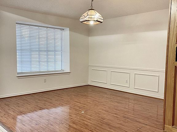 Another view of formal dining room with window seat looking out to park.