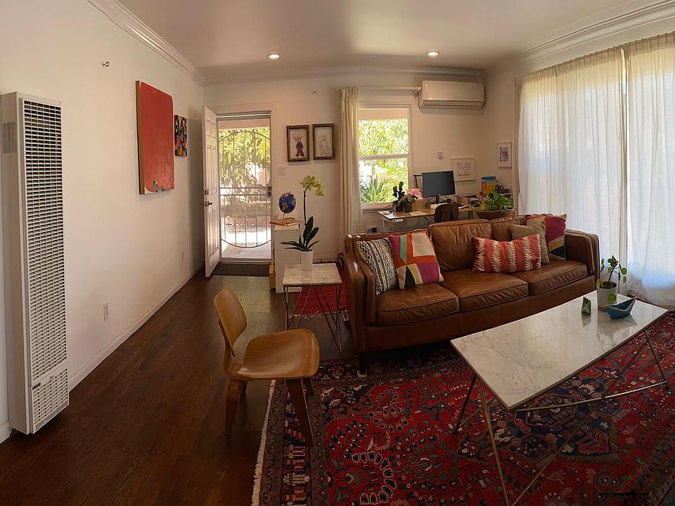 Large living room with lots of natural light, looking toward entrance.