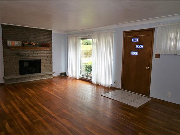 Living room, exposed hardwood throughout.