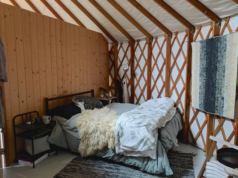 The cozy bedroom has a mountain view. You can pull down a shade to make it dark.
