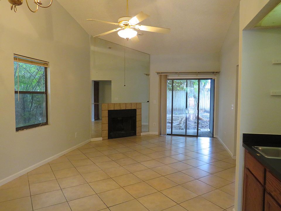 Living room with vaulted ceilings and sliding door to back yard.