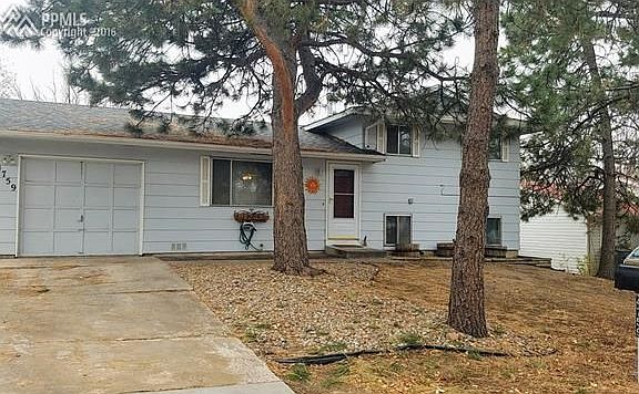 Landscaped front yard and great touches on the house like shutters and storm door.