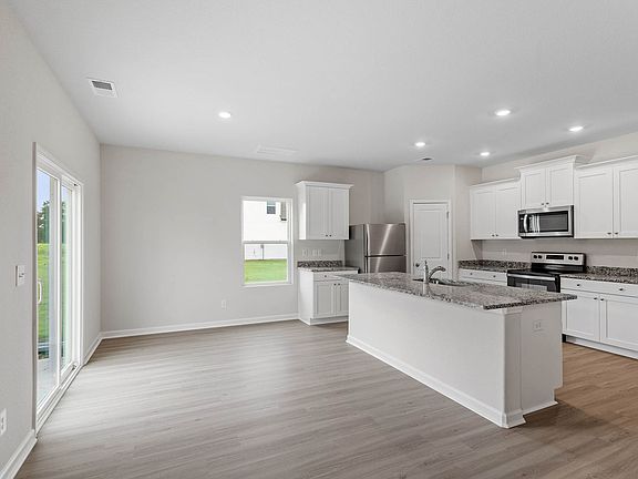 The kitchen opens to the dining room