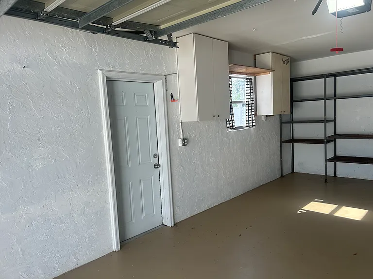 garage door to side yard with gate in front.