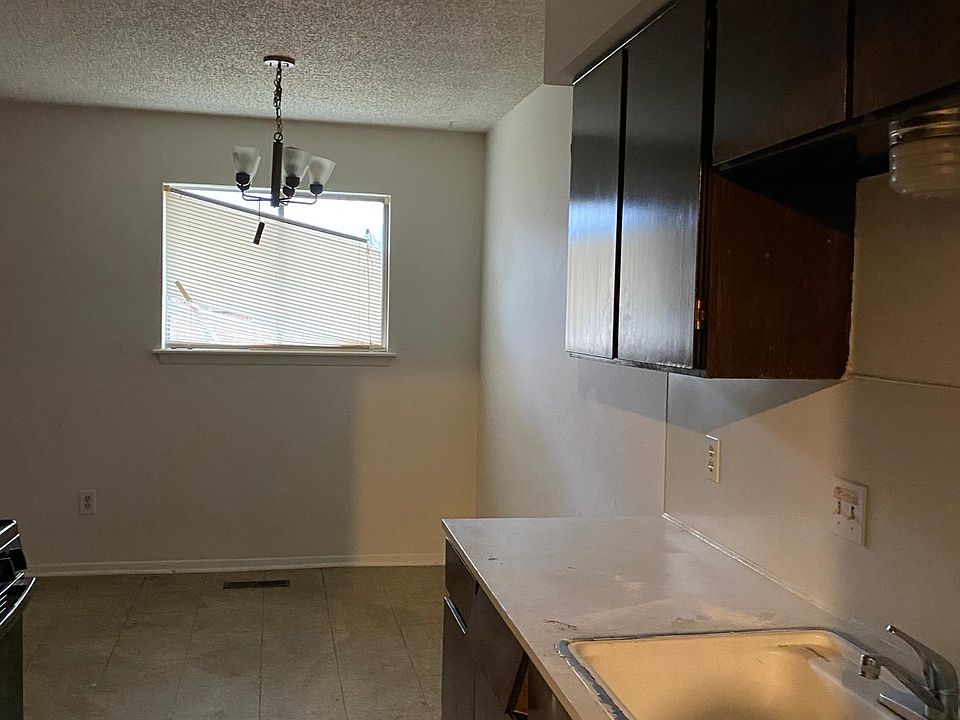 Kitchen with refrigerator and range