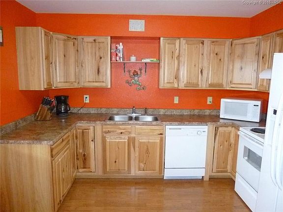 Upgraded kitchen with laminate flooring. Stove, dishwasher, kitchen vent fan, an