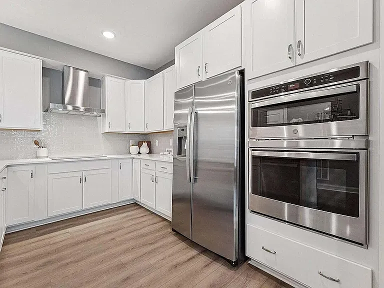 The gourmet kitchen showcases brand-new premium appliances perfect for preparing family meals, holidays, and entertaining.