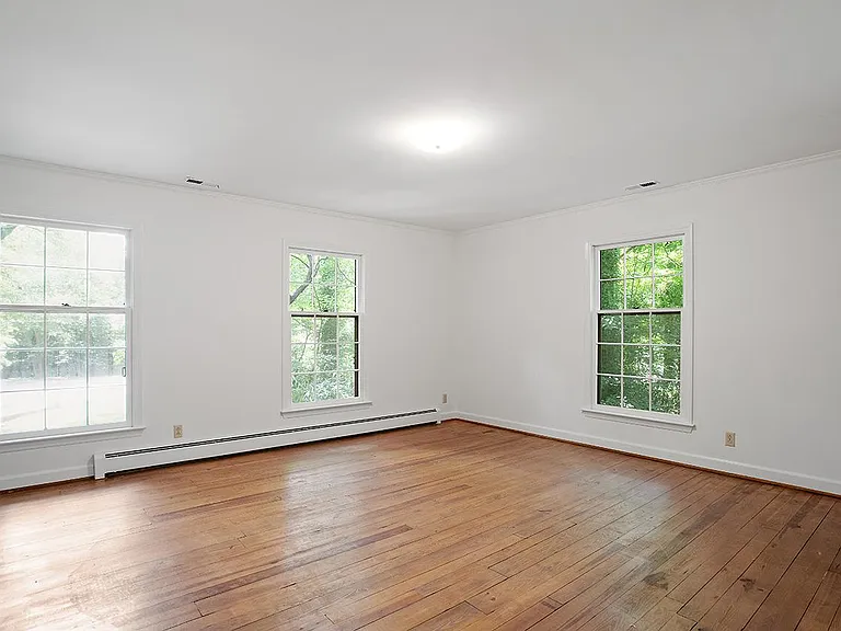 Large upstairs bedrooms with hardwood floors and large windows