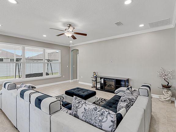 Spacious living area filled with natural light and direct flow to the kitchen and patio.