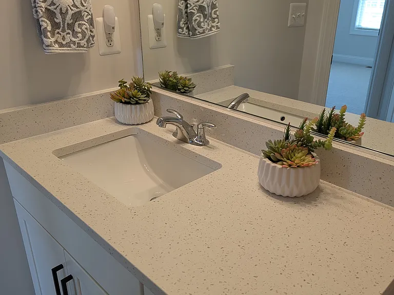 Quartz bathroom vanities in both full baths