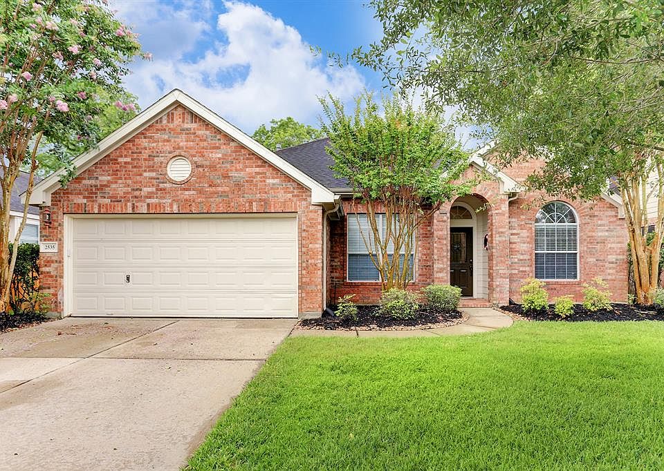 Mature trees flank the exterior of the home creating a nice welcome to the home.