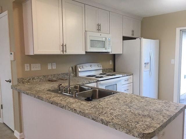 View of new kitchen cabinets and appliances